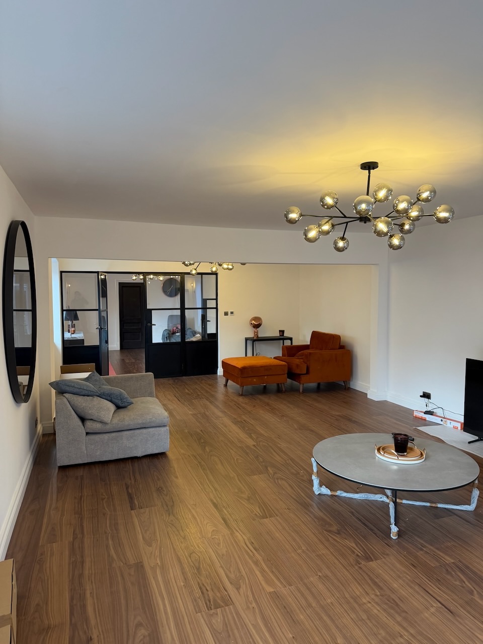 Bungalow living room with statement chandelier and crittall partition wall, Westby, Lytham — Wilsons Systems