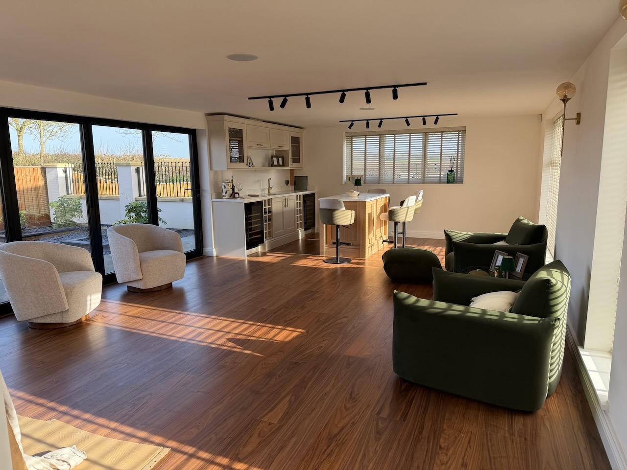Bungalow open-plan kitchen and living space with black track lighting and bifold doors, Westby, Lytham — Wilsons Systems